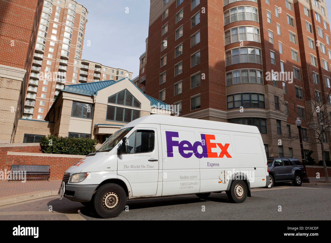 FedEx delivery van parked in front of apartment building - Arlington, Virginia USA Stock Photo