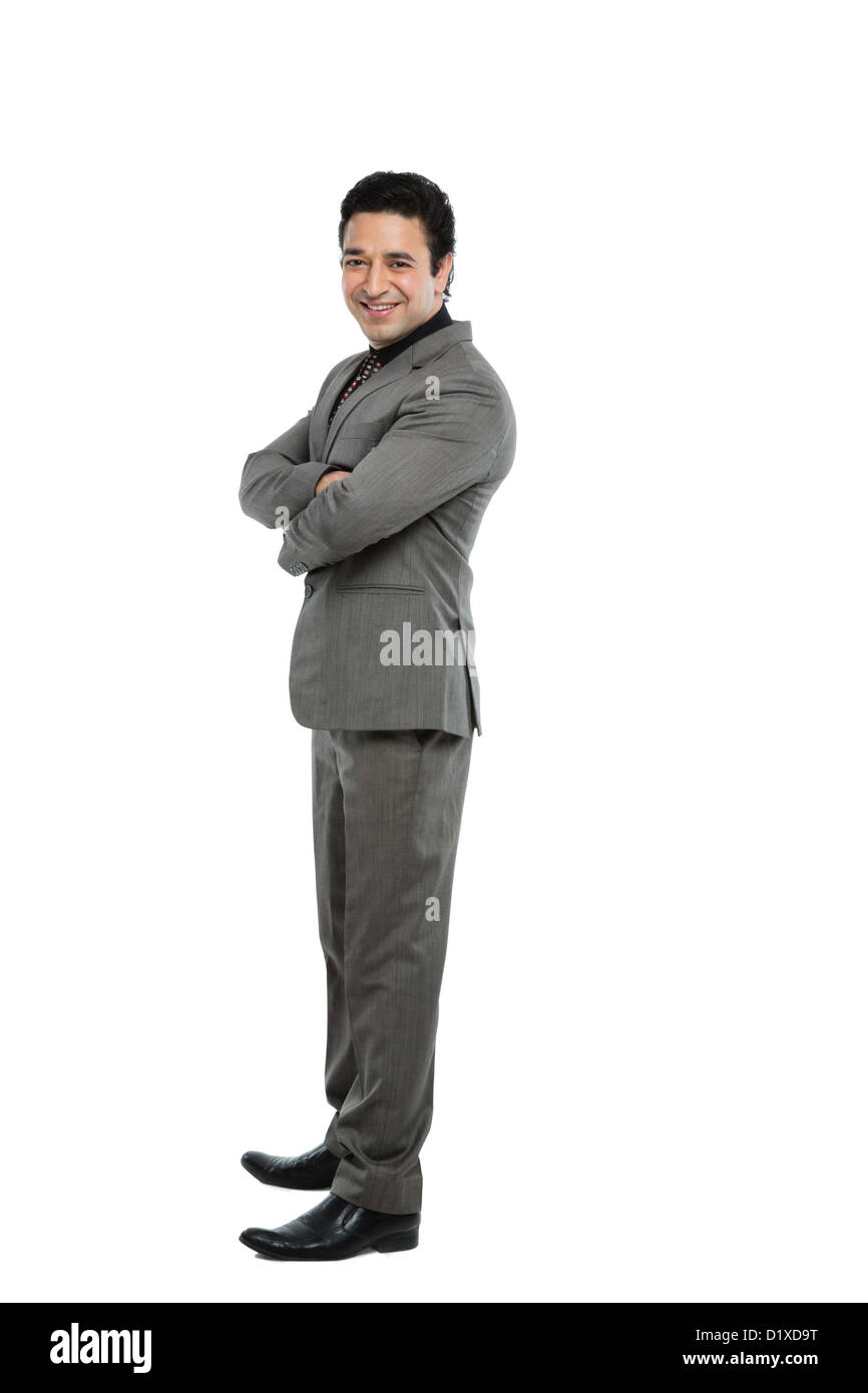 Portrait of a businessman standing with arms crossed and smiling Stock ...