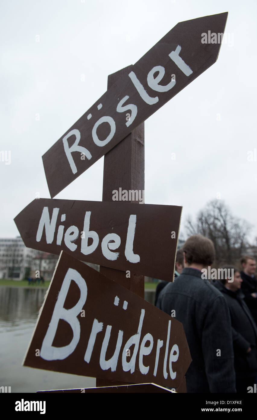 A sign post pointing in opposing directions features the names of the chairman of the FDP, Philipp Roesler, German Minister for Economic Cooperation and Development and the chairman of the FDP's parliamentary fraction Rainer Bruederle, outside the conference centre during the annual Epiphany party conference of the FDP in Stuttgart, Germany, 6 January 2013. Photo: Marijan Murat Stock Photo