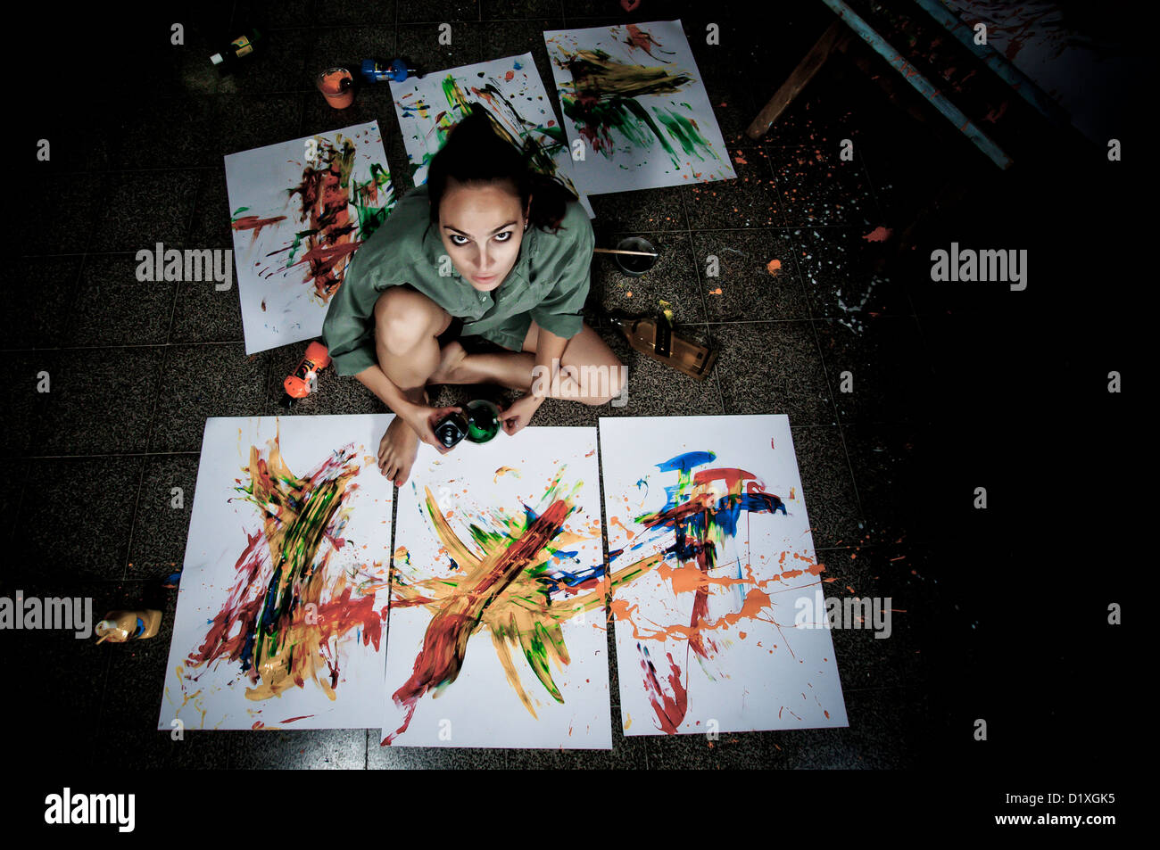 A young female artist painter works in her studio Stock Photo - Alamy