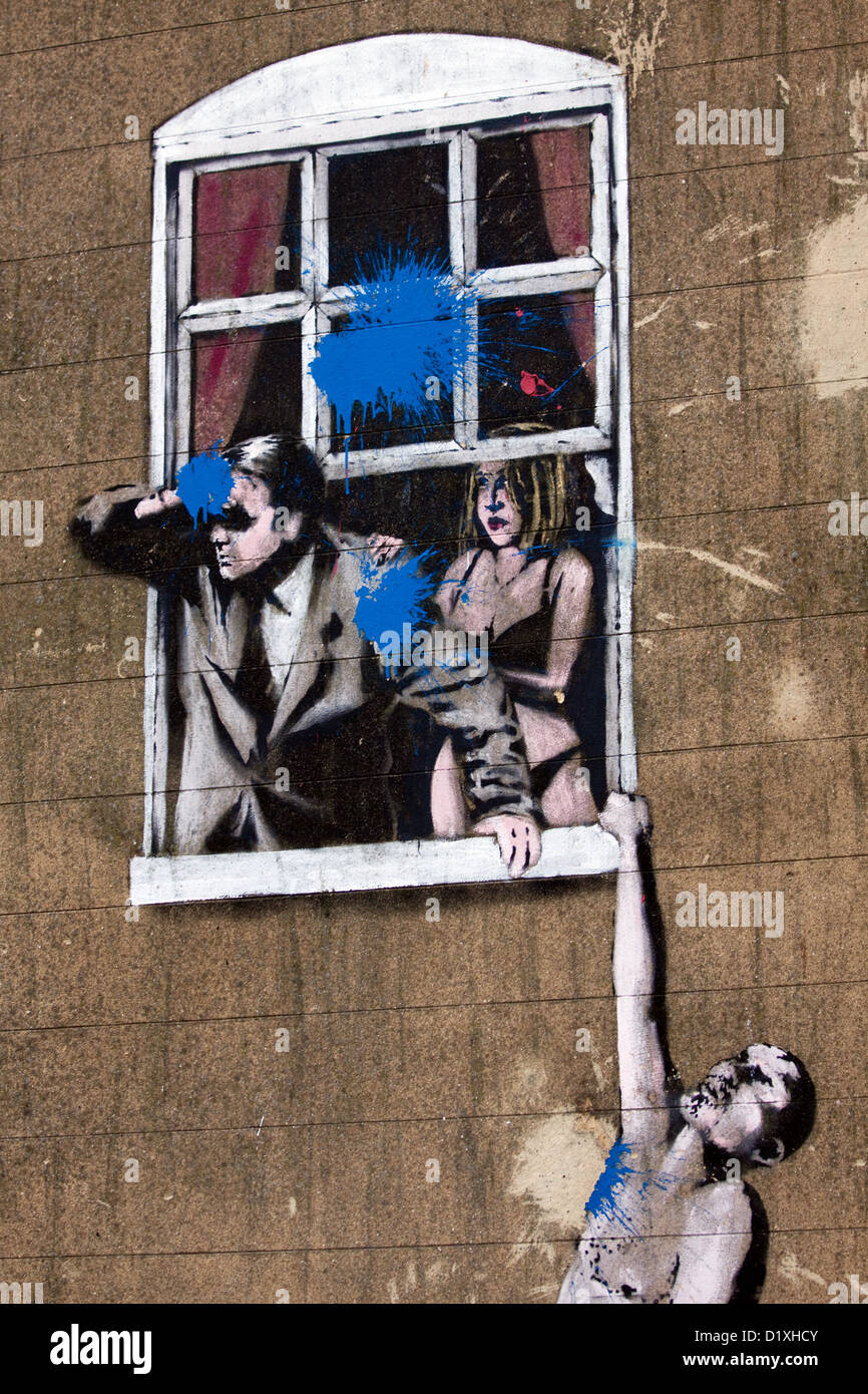 Paintbombed Banksy artwork known as The Window Lovers or Hanging