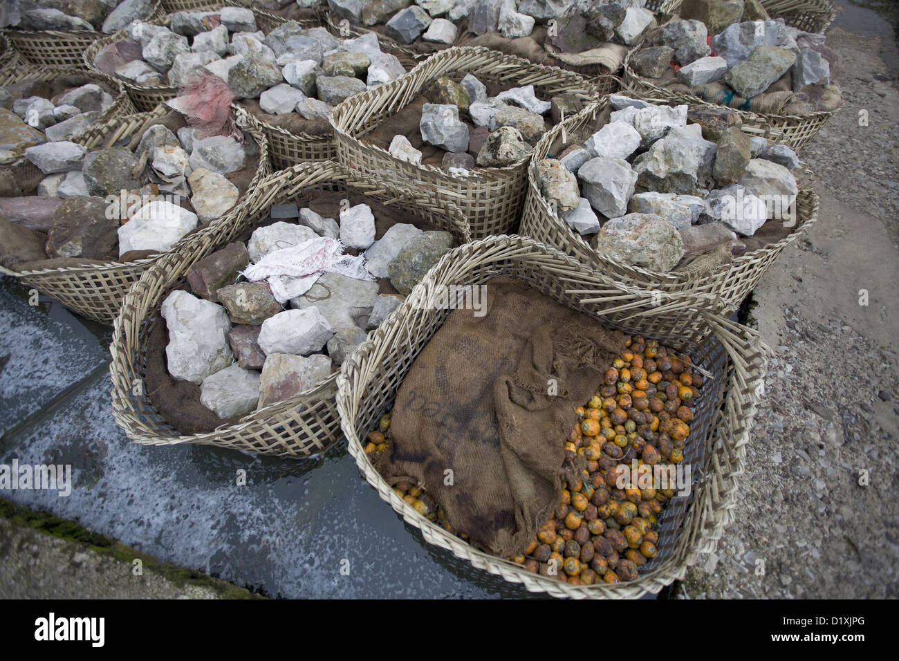Baskets with Supari.  (areca nut ) Stones on top. Cherrapunjee, Meghalay, India Stock Photo