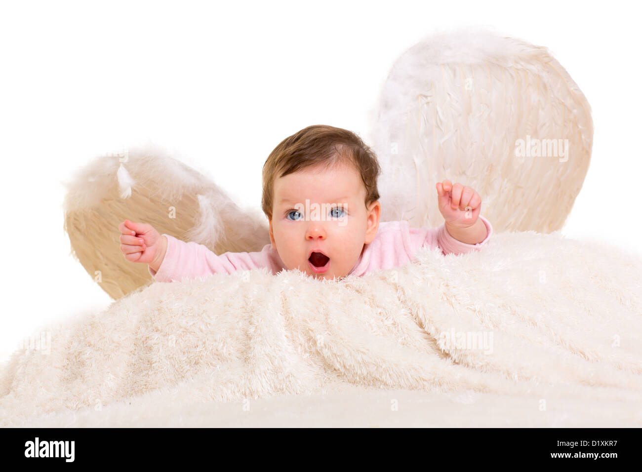 baby girl angel with feather white wings on white fur and open arms Stock Photo