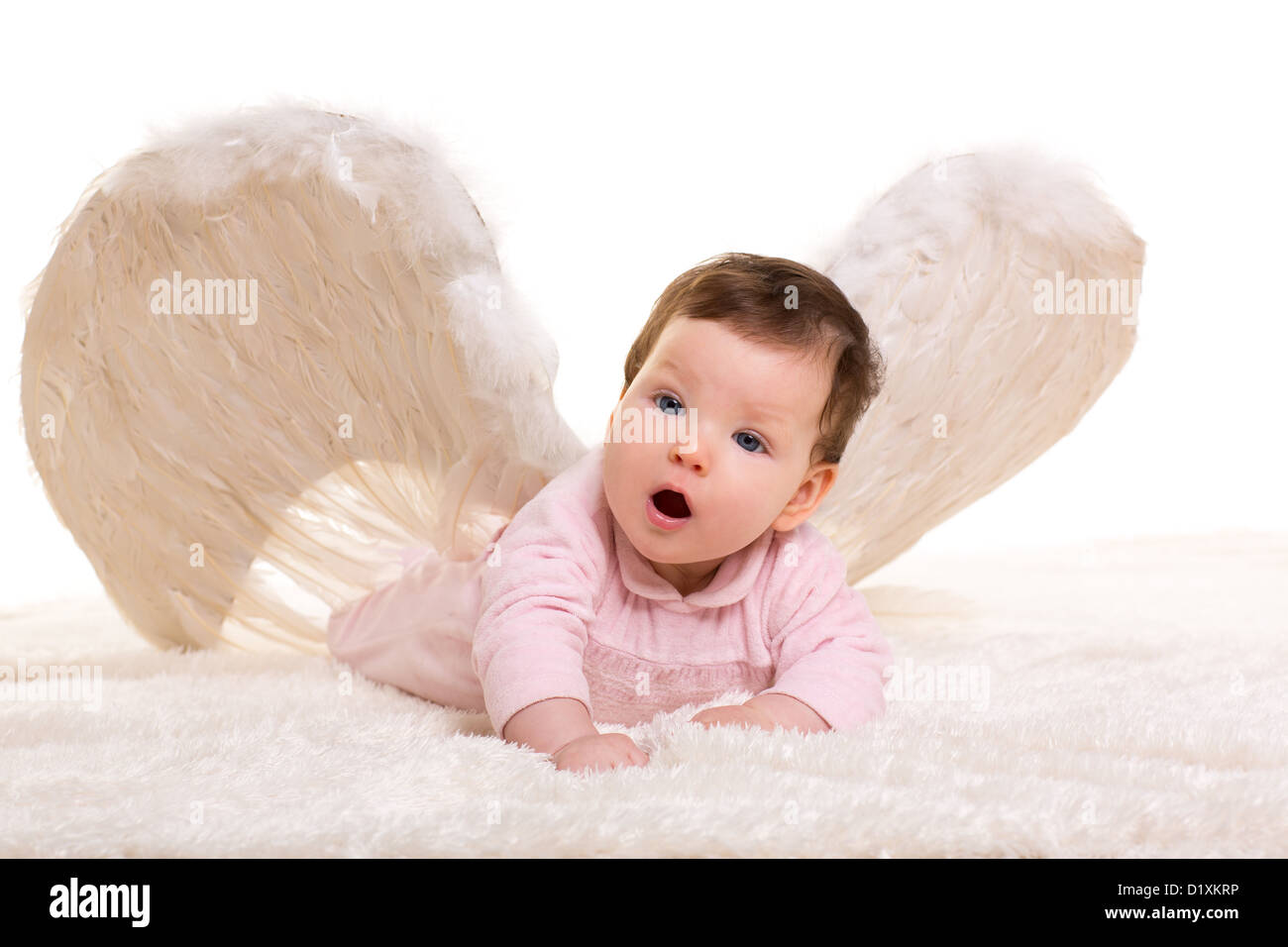 baby girl angel with feather white wings on white fur Stock Photo