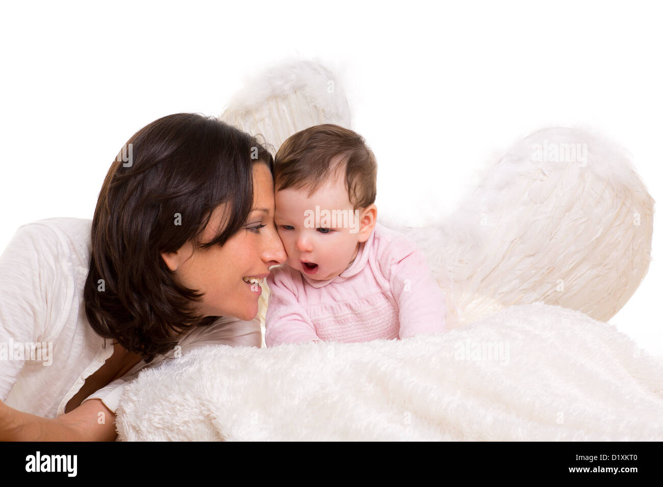 baby girl angel with feather white wings and mother on white fur Stock Photo
