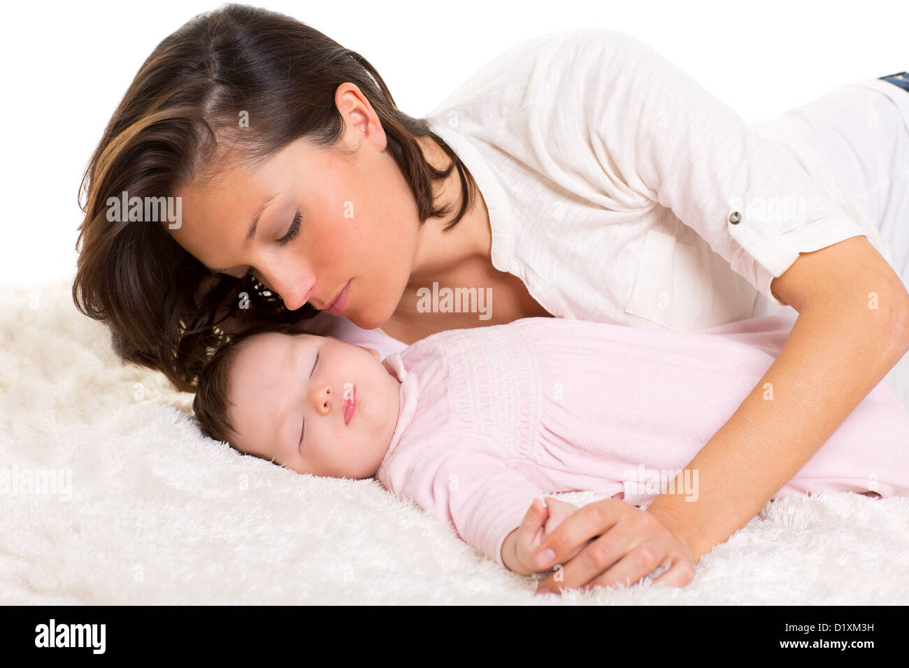 Baby girl sleeping with mother care near on white fur Stock Photo Alamy