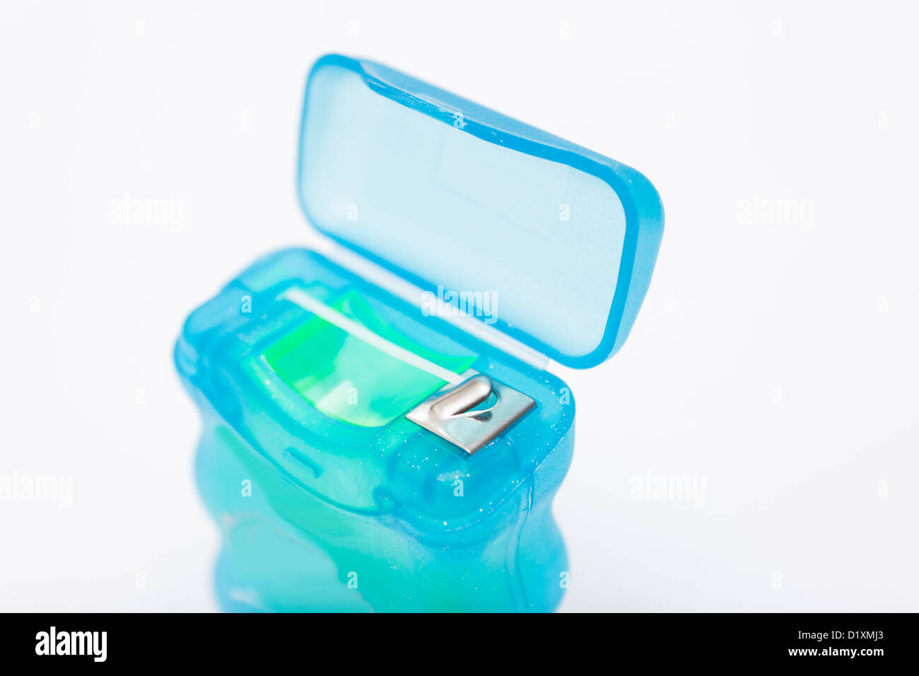 Large reel of dental floss used to clean between teeth and gums. Lid