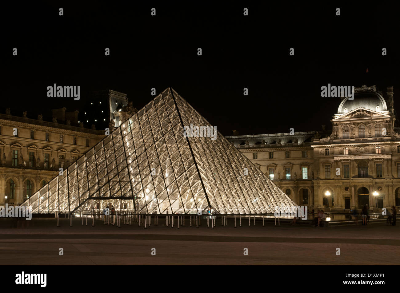 The Louvre Pyramid is a large glass and metal pyramid in the main courtyard of the Louvre Palace, Paris. Stock Photo