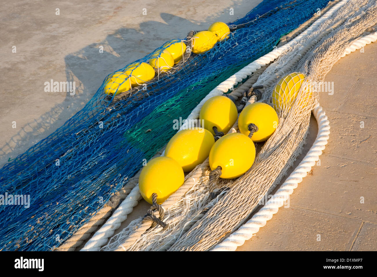 Port de Sóller, Mallorca, Balearic Islands, Spain. Colourful fishing nets and floats on the quay. Stock Photo