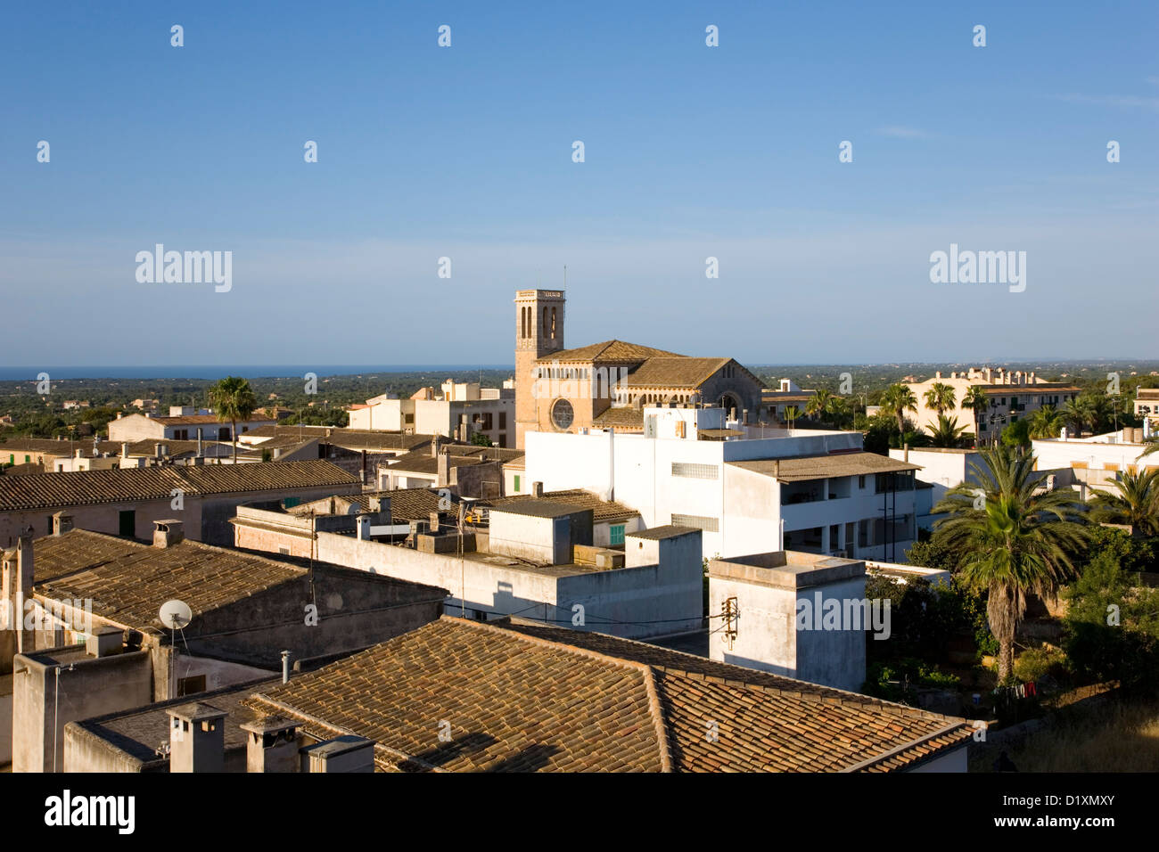 Calonge, Mallorca, Balearic Islands, Spain. View across rooftops to the village church. Stock Photo