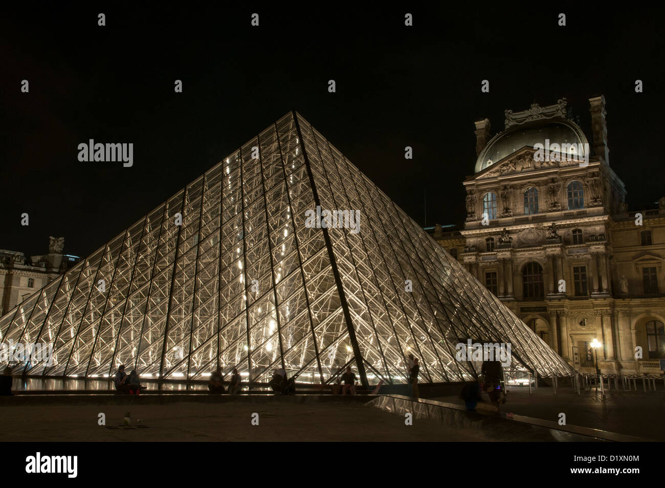 The Louvre Pyramid is a large glass and metal pyramid in the main courtyard of the Louvre Palace, Paris. Stock Photo