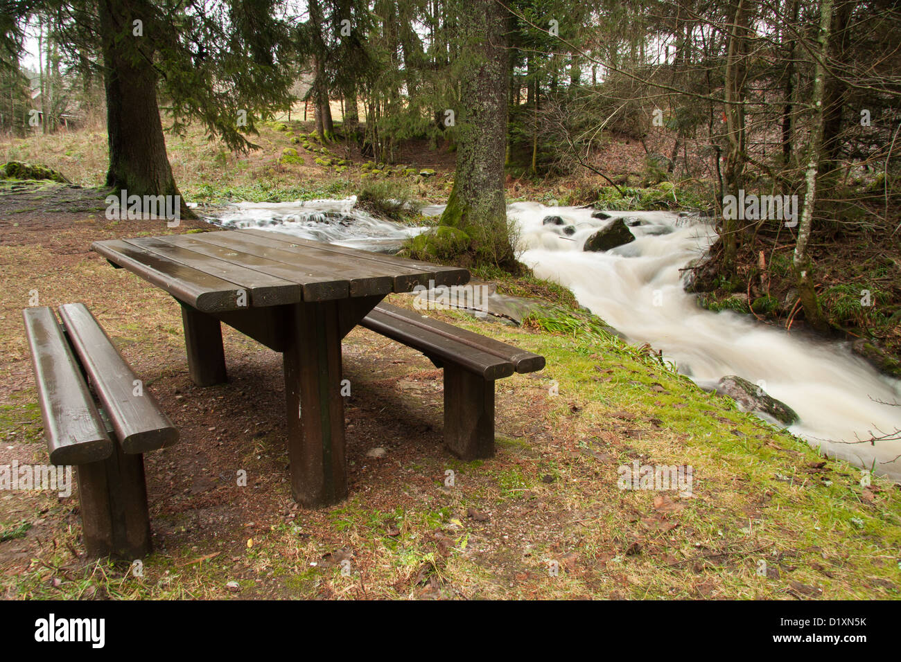 picnic bench along a river Stock Photo Alamy
