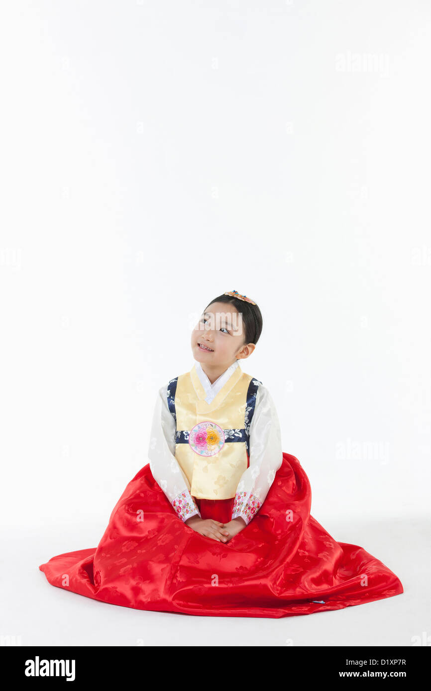 a girl looking up in the side ways wearing a Hanbok dress Stock Photo