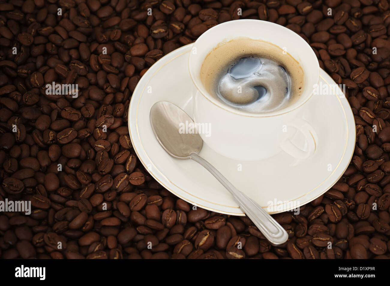cup of coffee with teaspoon on coffee beans background Stock Photo Alamy
