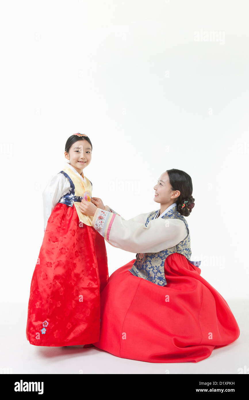 mother fixing daughter's Hanbok Stock Photo