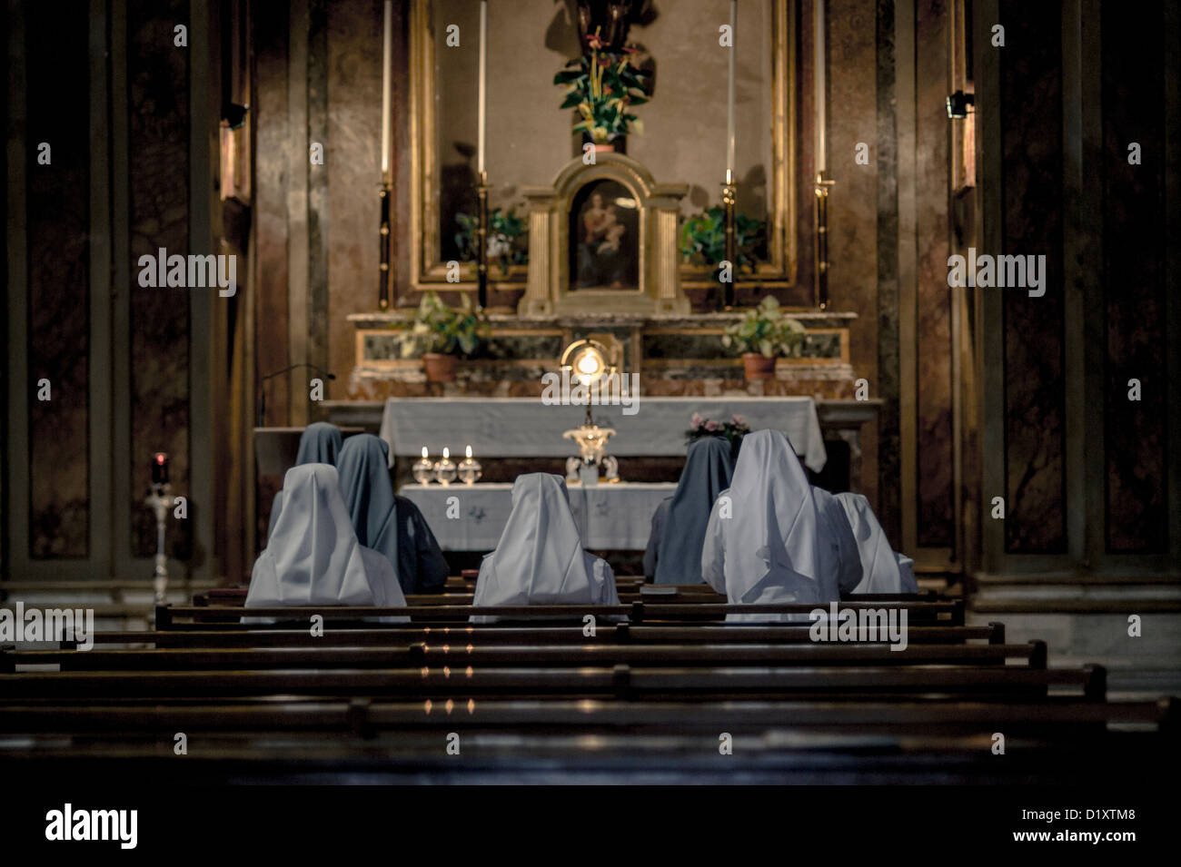 Nuns praying inside a church, Rome, Italy Stock Photo