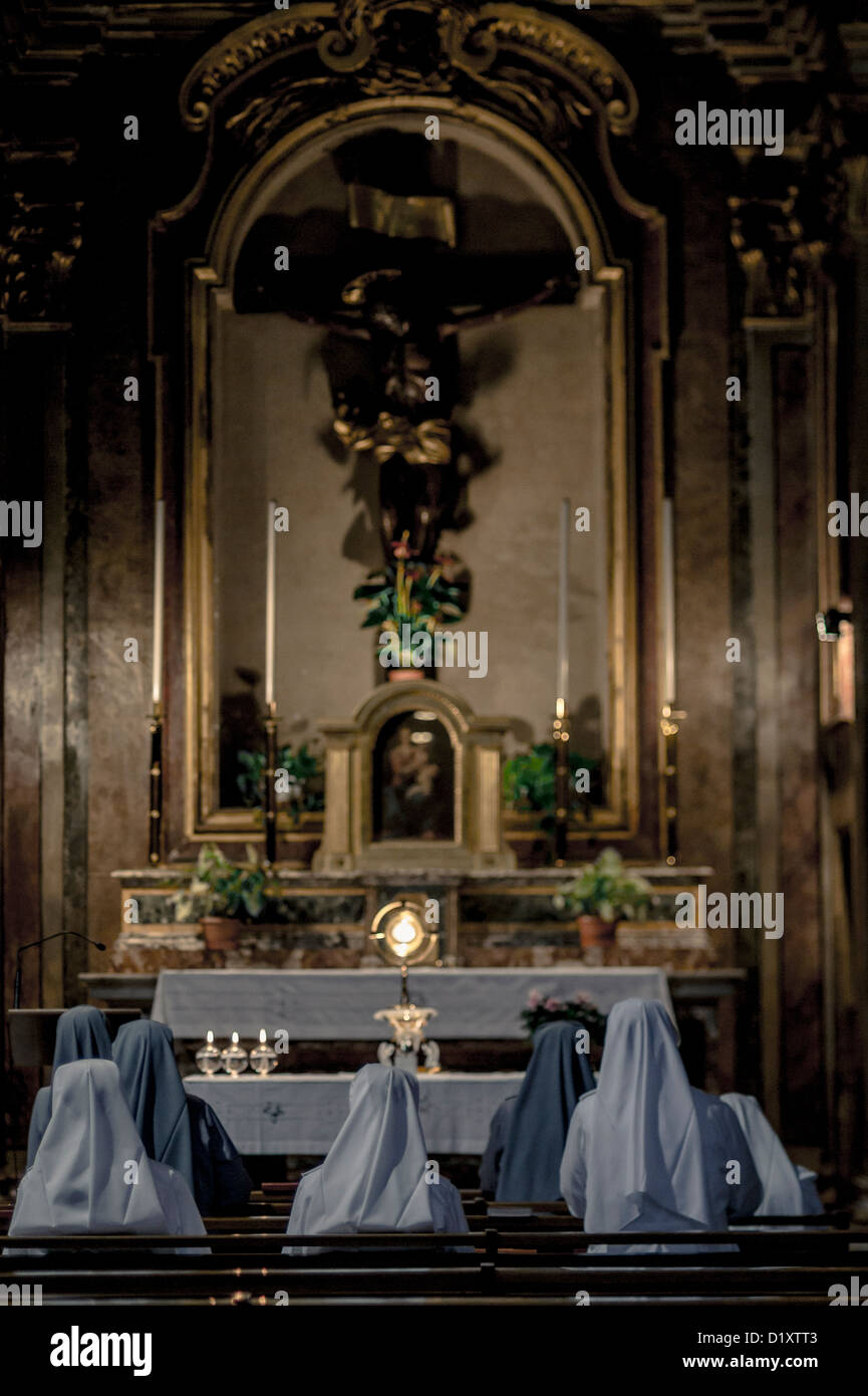 Nuns praying inside a church, Rome, Italy Stock Photo
