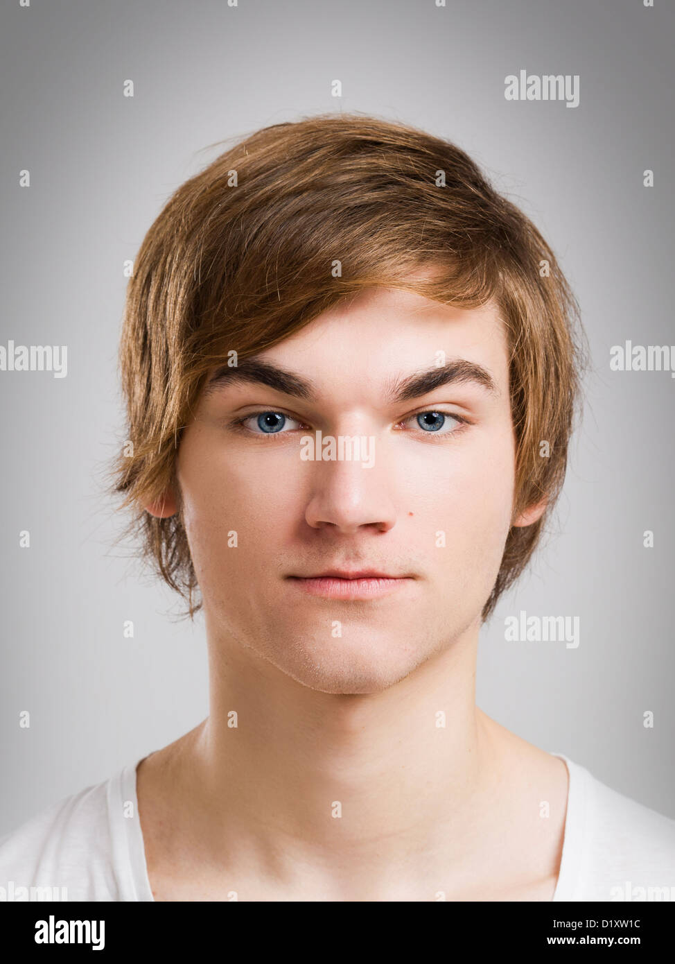 Portrait of a handsome young man, over a gray background Stock Photo ...