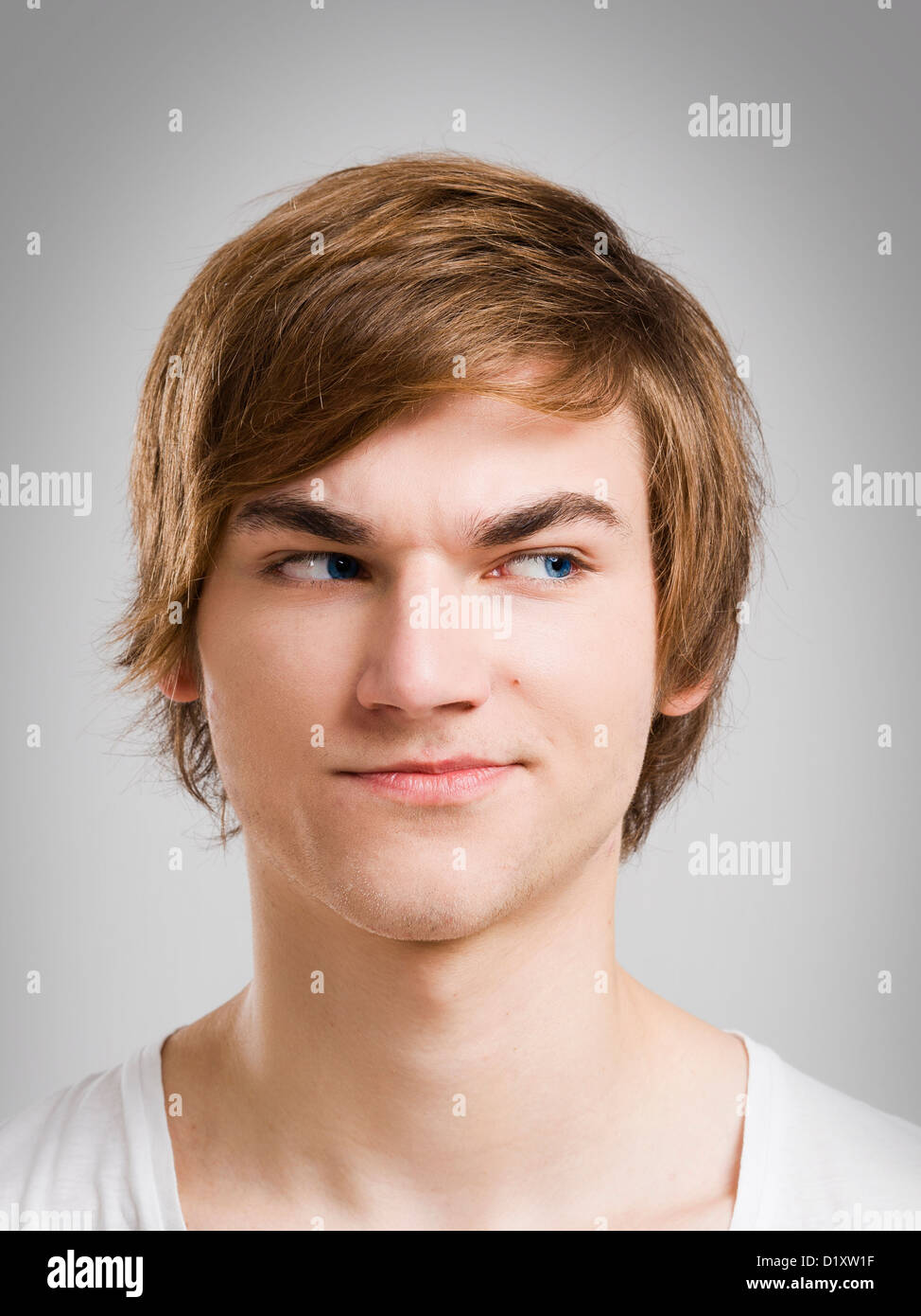 Portrait of a handsome young man, over a gray background Stock Photo ...