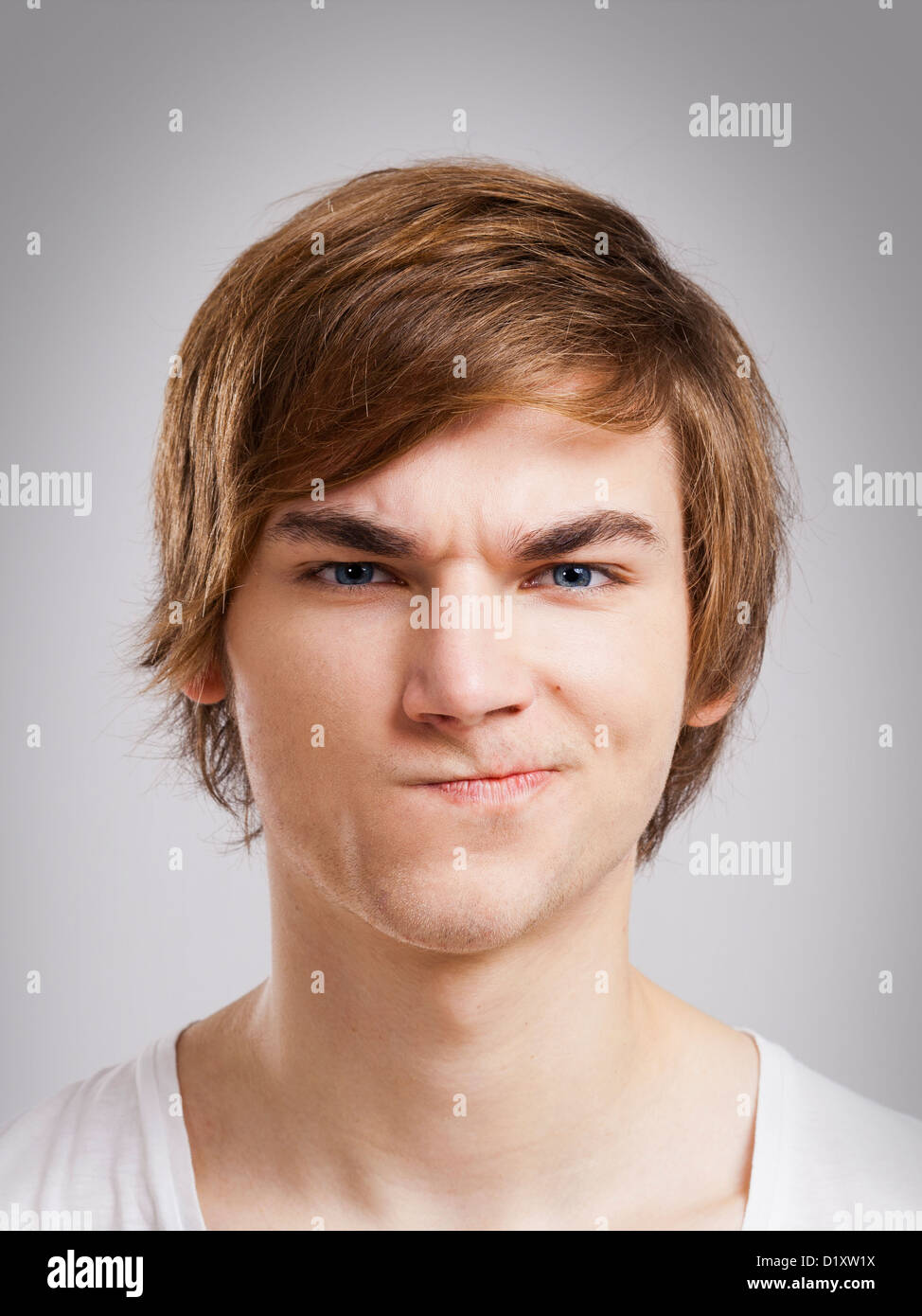 Portrait of a handsome young man, over a gray background Stock Photo ...