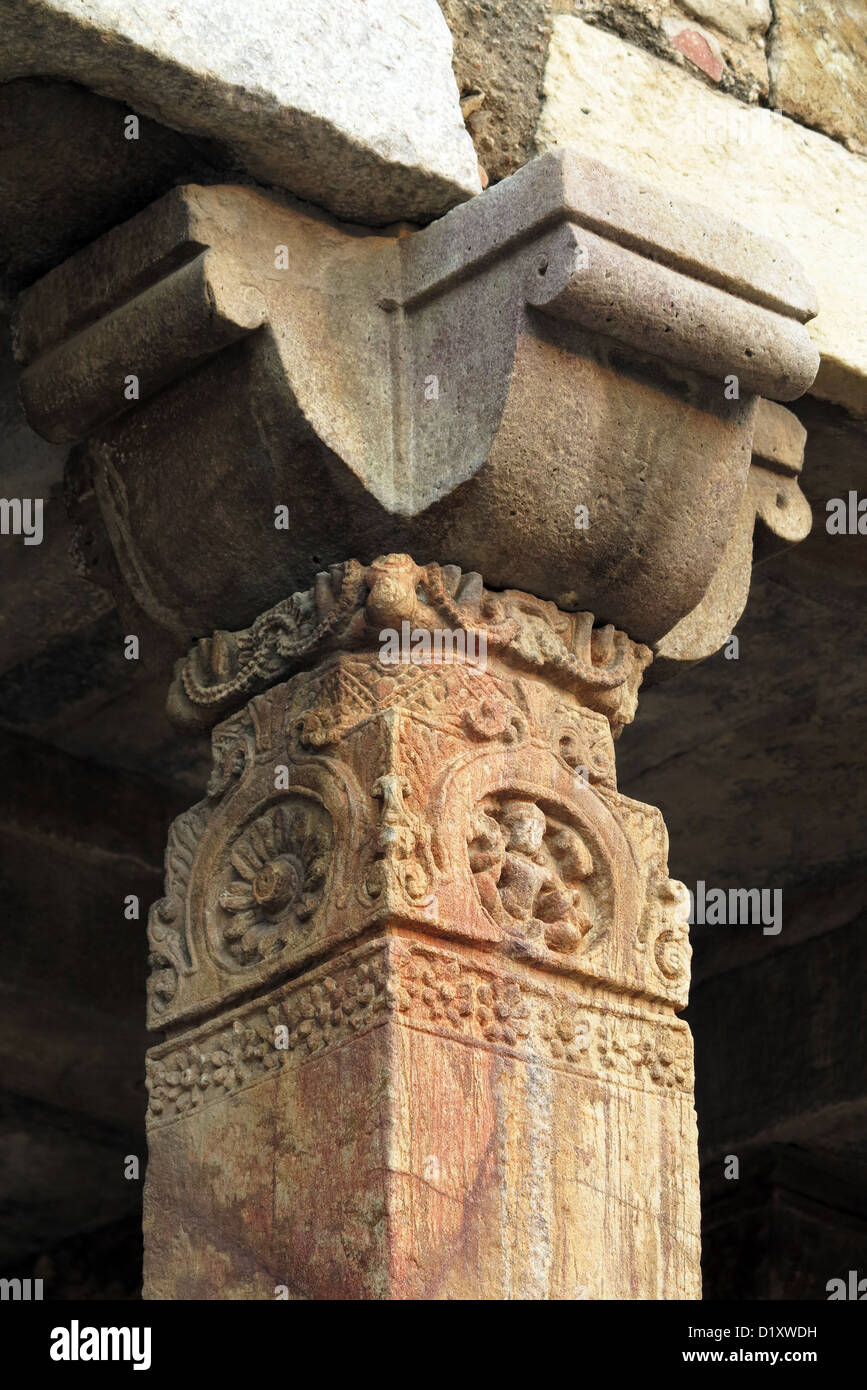 Carved pillars in cloister of Quwwat UI Islam Mosque in the Qutb Minar complex in Delhi, India Stock Photo