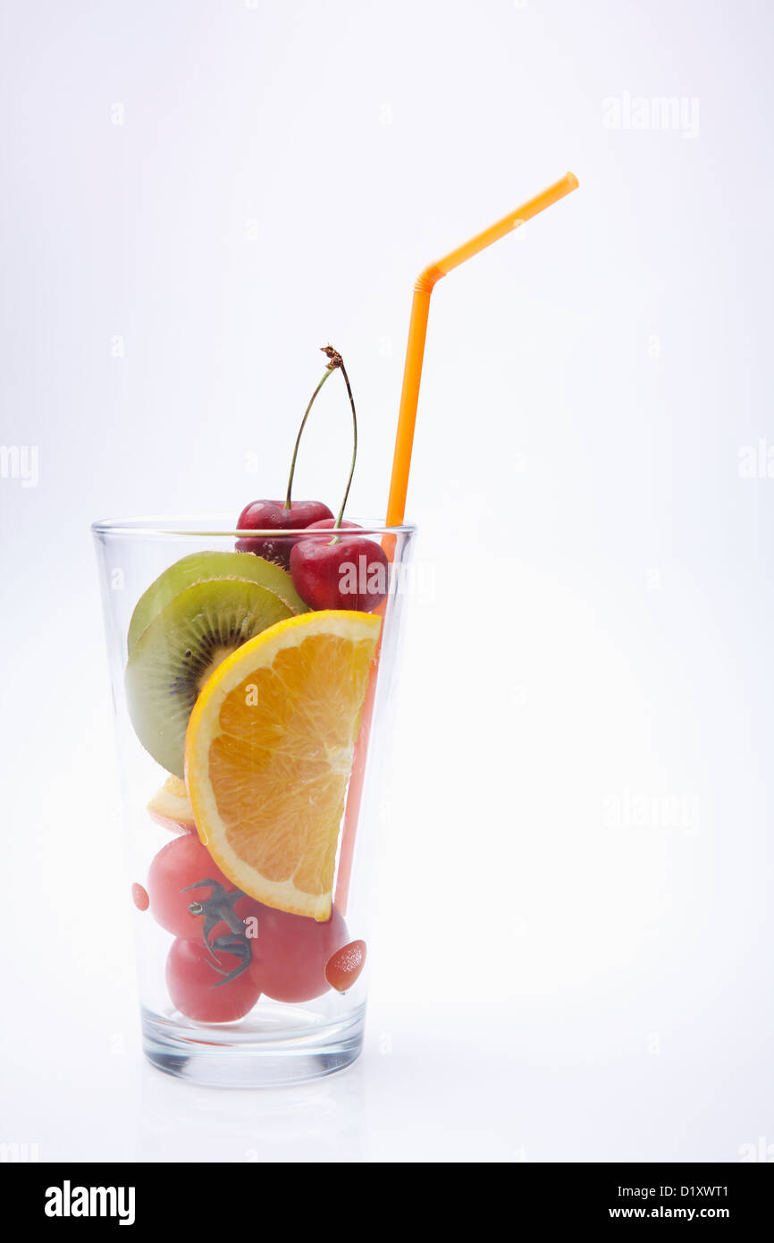 a cup filled with cut fruits Stock Photo