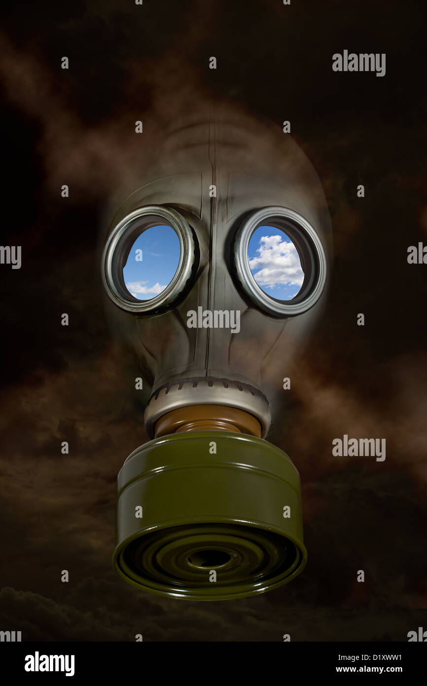 A gas mask amidst toxic fumes with blue sky behind the mask. Stock Photo