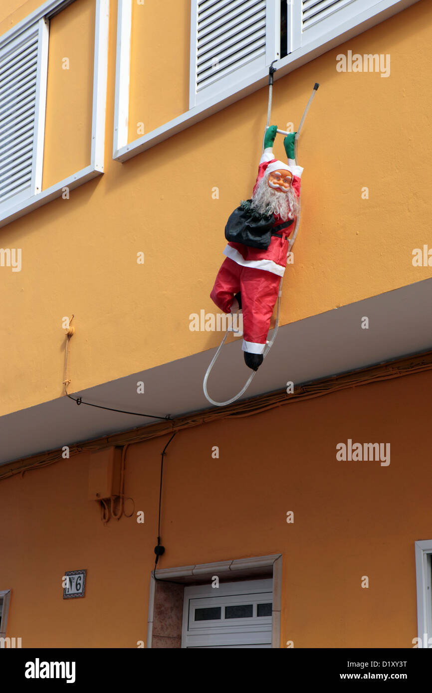 Santa Claus, Father Christmas decoration hanging from shuttered window, Puerto de la Cruz, Tenerife, Canary Islands Stock Photo