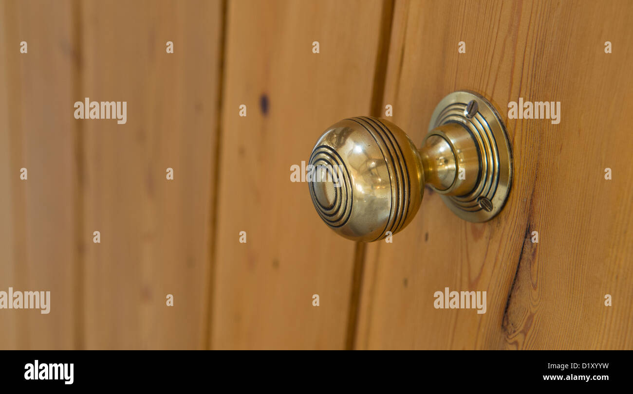 Beautifully polished brass door knob on a new door in a newly built property. Stock Photo