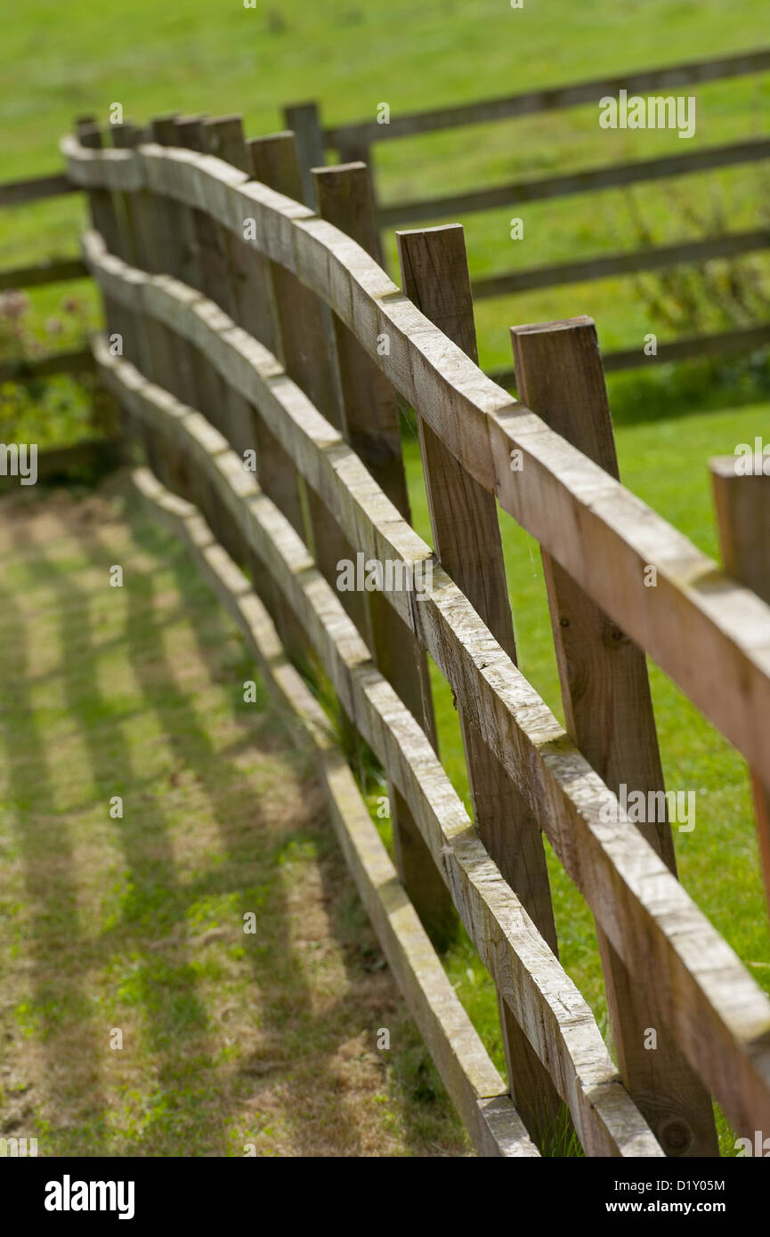Timber post and rail fencing in a rural garden in England Stock Photo