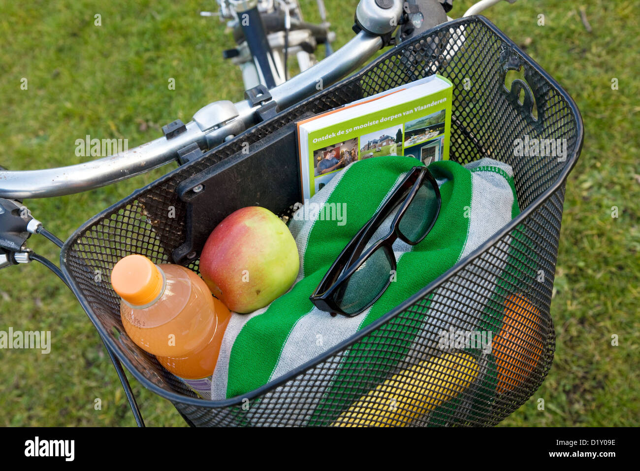 Bike with bicycle basket filled with picnic and holiday goods during the summer holidays Stock Photo