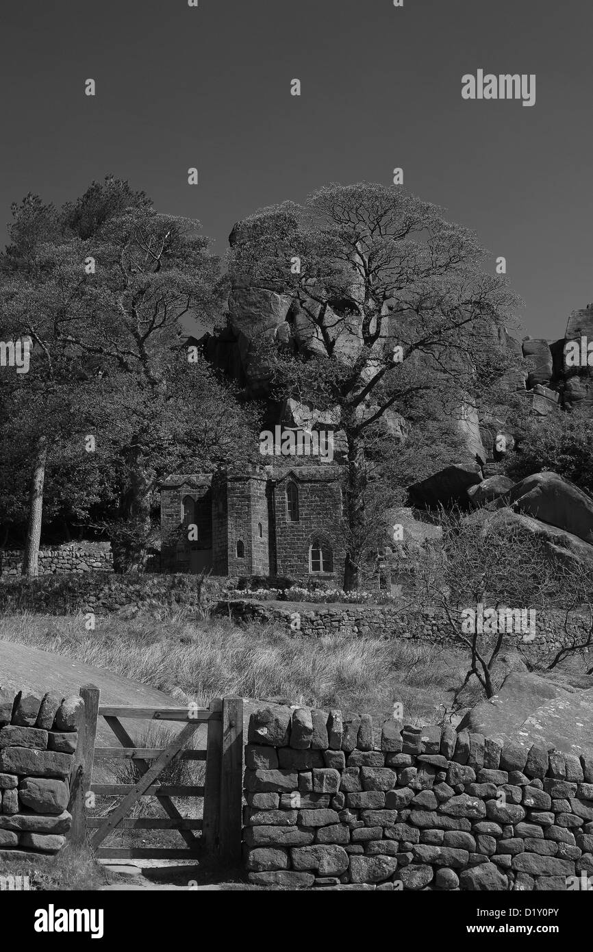 View of Rock Hall Cottage which lies at the bottom of the Roaches Sandstone rock formations Upper Hulme village, Staffordshire Stock Photo