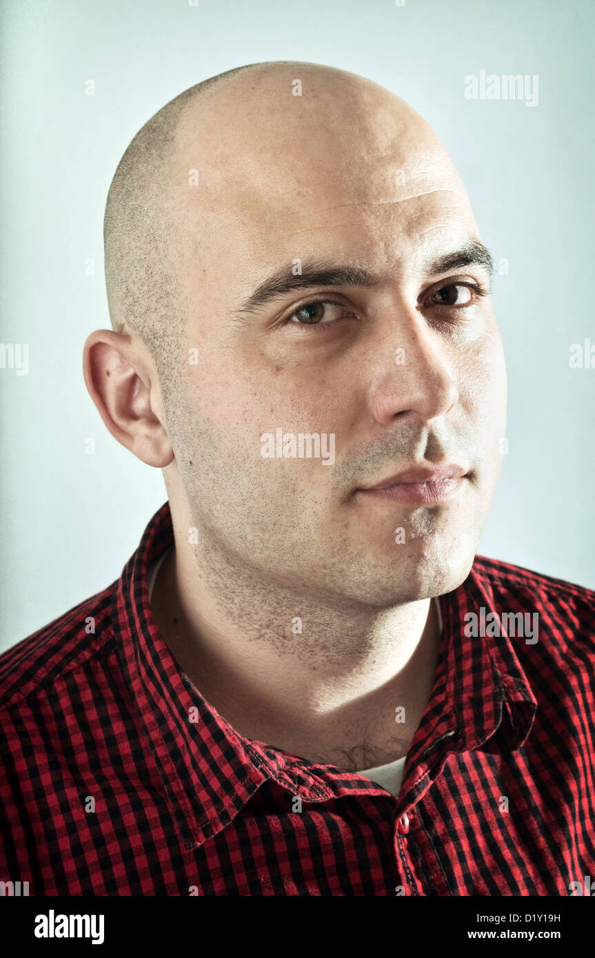 Portrait of serious young adult bald male Stock Photo