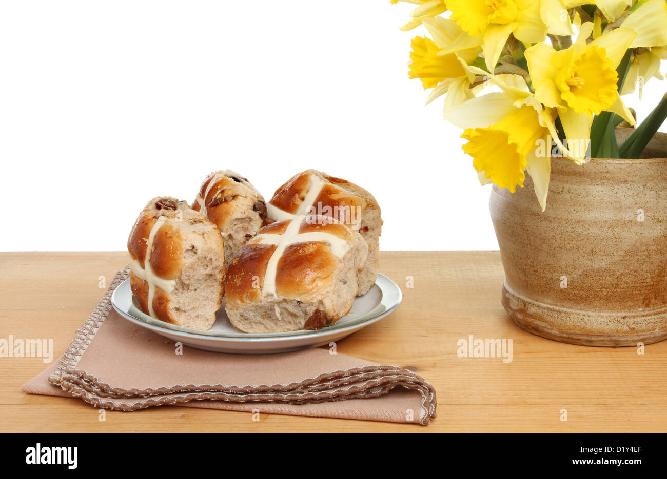 Easter theme, hot cross buns with daffodil flowers on a wooden table Stock Photo