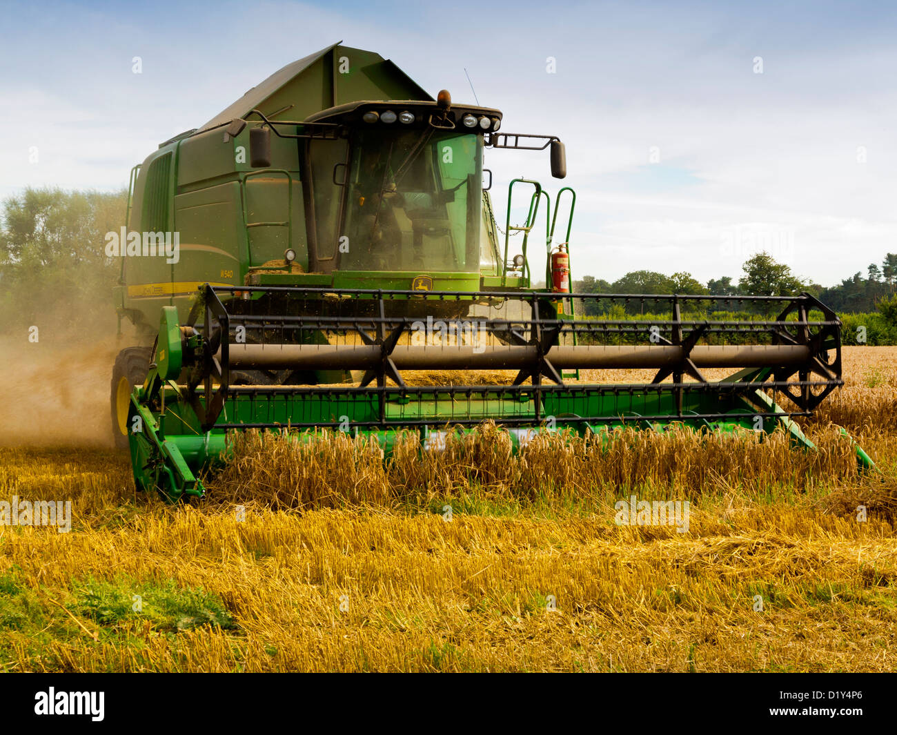 John Deere combine harvester working in a field in Shropshire England UK Stock Photo