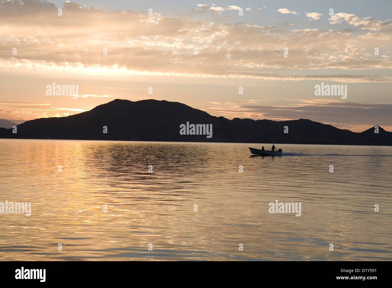 Sunrise Landscape with a boat on the ocean Stock Photo - Alamy