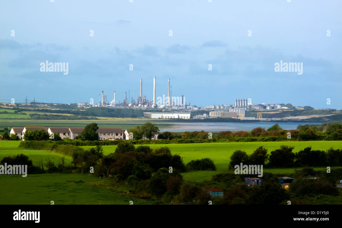 Distant view across fields from Pembroke of Milford Haven oil refinery and LNG gas terminal Pembrokeshire South Wales UK Stock Photo