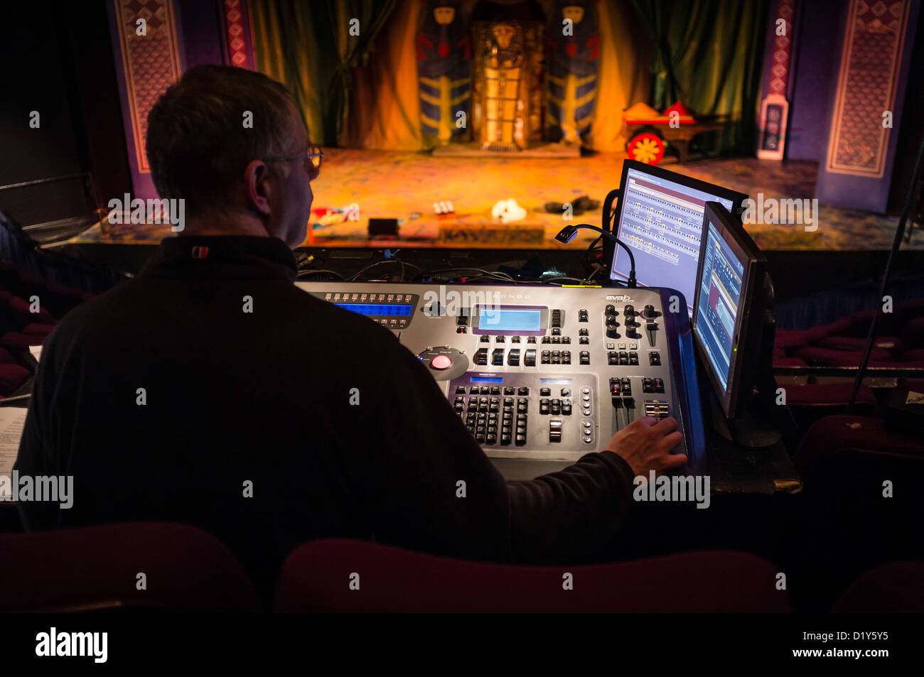 A man operating a digital lighting board control desk at a professional  theatre venue UK Stock Photo - Alamy