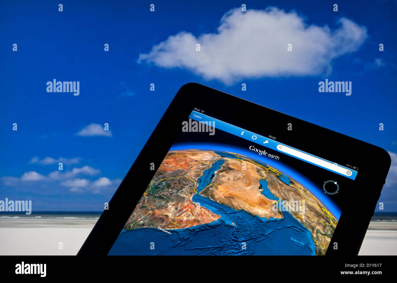 MAP TABLET iPad computer  with Google Earth application screen with Suez Canal Middle East, Red Sea, Gulf & Arabian Sea, sky cloud background Stock Photo
