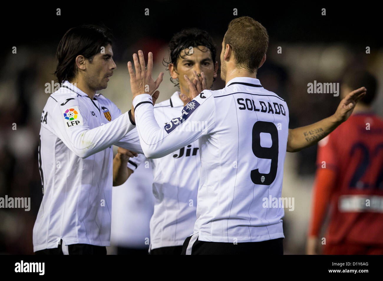 08.01.2013. Valencia, Spain. Forward Roberto Soldado of Valencia CF (R) Celebrates with Ever Banega (L) and Tino Costa after Scoring the victory goal in extra time during the Spanish Kings Cup game between Valencia and Osasuna from the Mestalla. Stock Photo