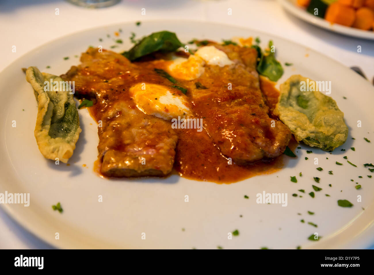 A dish of Veal with fried sage leaves in a restaurant in Turin Italy Stock Photo