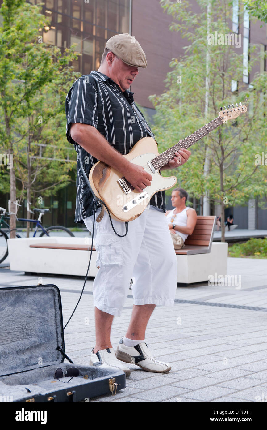Street musician playing electric guitar on SteCatherine street in
