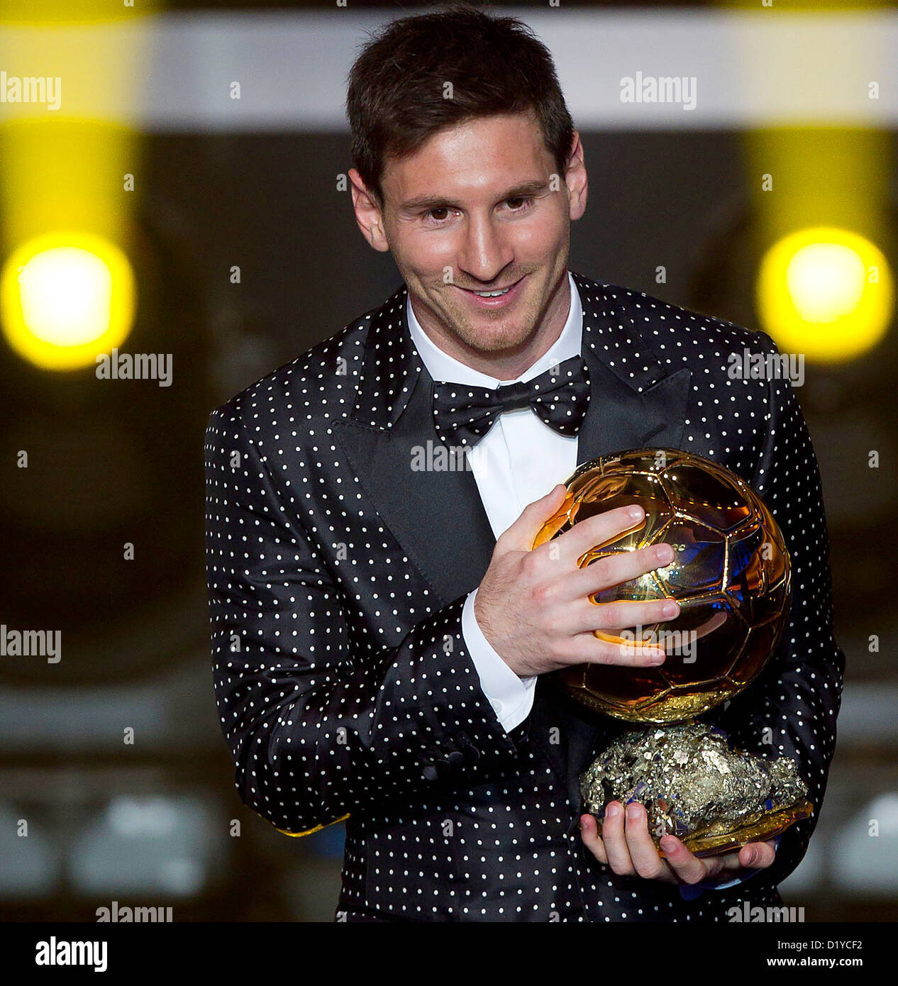 Lionel Messi of Argentina holds the trophy alloft after winning the FIFA Ballon  d'Or for a fourth consecutive time during FIFA Ballon d'Or Gala 2012 at the  Kongresshaus on January 7, 2013