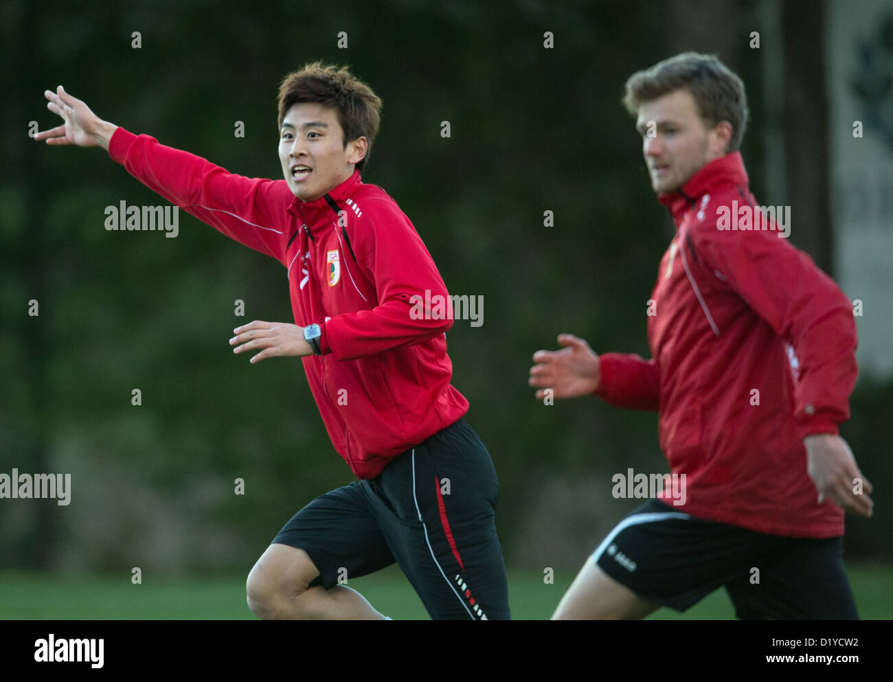 Augsburg's player Ja-Cheol Koo (l)asks for the ball during a practice session of Bundesliga soccer club FC Augsburg in the training camp in Belek, Turkey, 7 January 2013. In front of him runs his teammate Stephan Hain. Photo: Soeren Stache Stock Photo