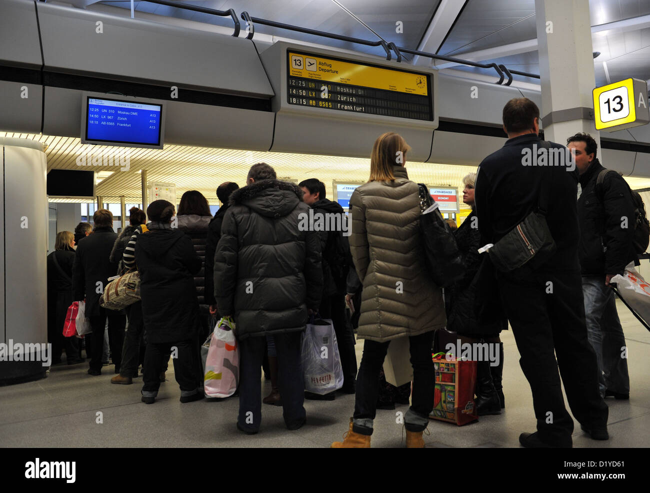People queue at the check-in counter at airport Tegel in Berlin, Germany, 08 January 2013. After the renewed delay of the opening of the new Berlin airport BER, services at Tegel airport will be continued for an indefinite period. Photo: Paul Zinken Stock Photo