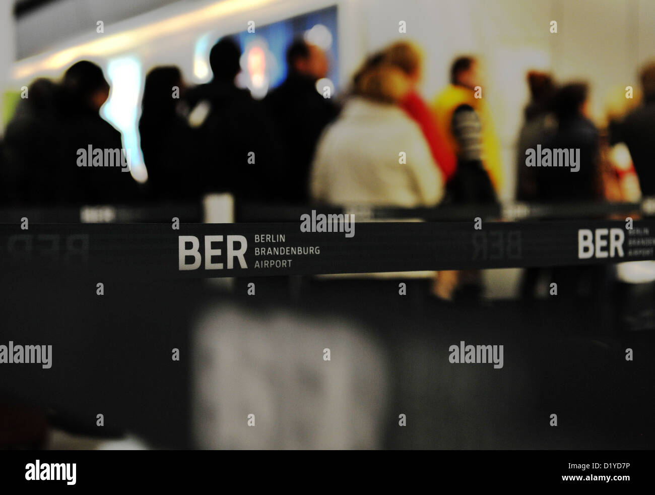 People queue at the check-in counter at airport Tegel in Berlin, Germany, 08 January 2013. After the renewed delay of the opening of the new Berlin airport BER, services at Tegel airport will be continued for an indefinite period. Photo: Paul Zinken Stock Photo