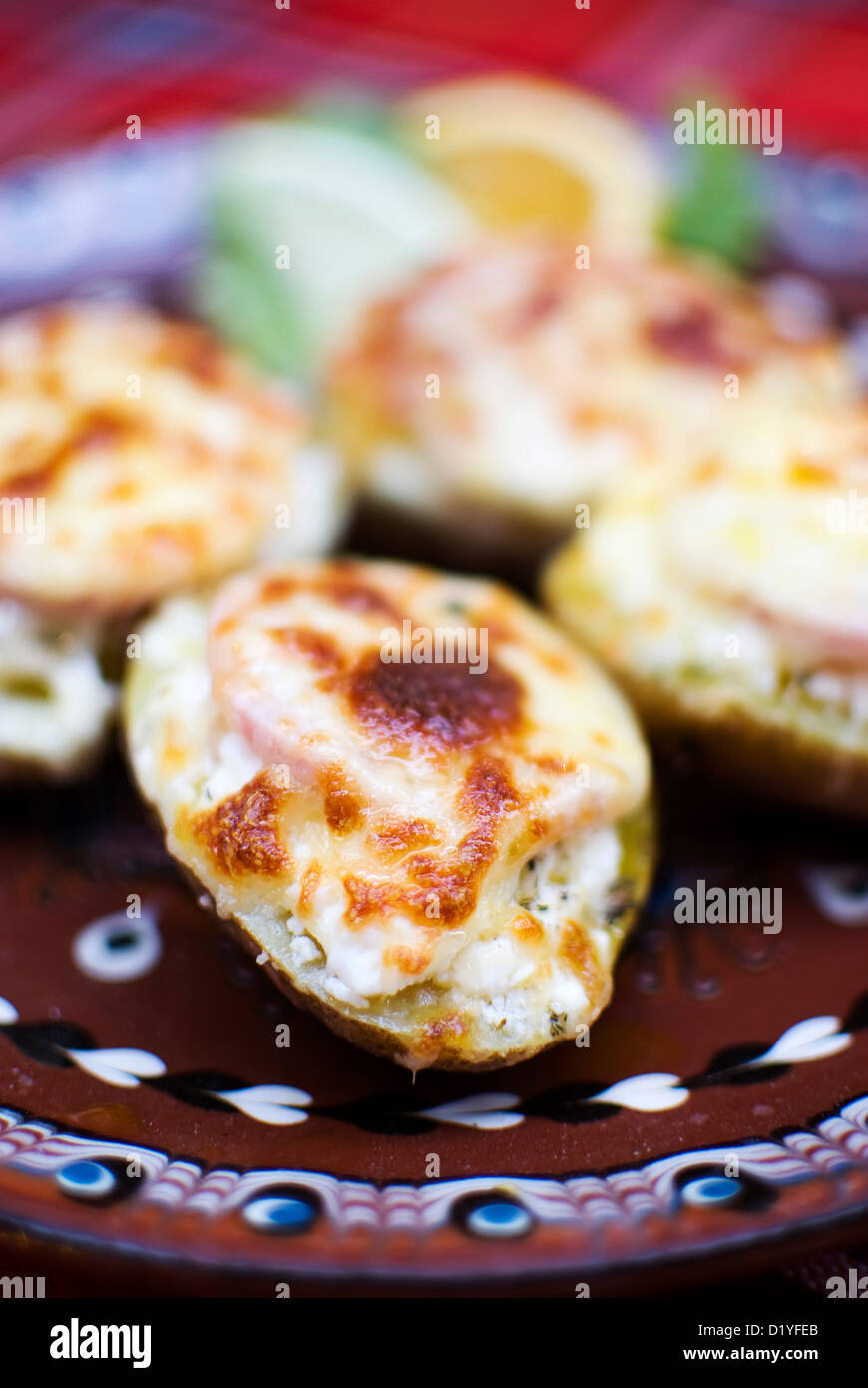 sliced potatoes covered with ham and cheese Stock Photo - Alamy