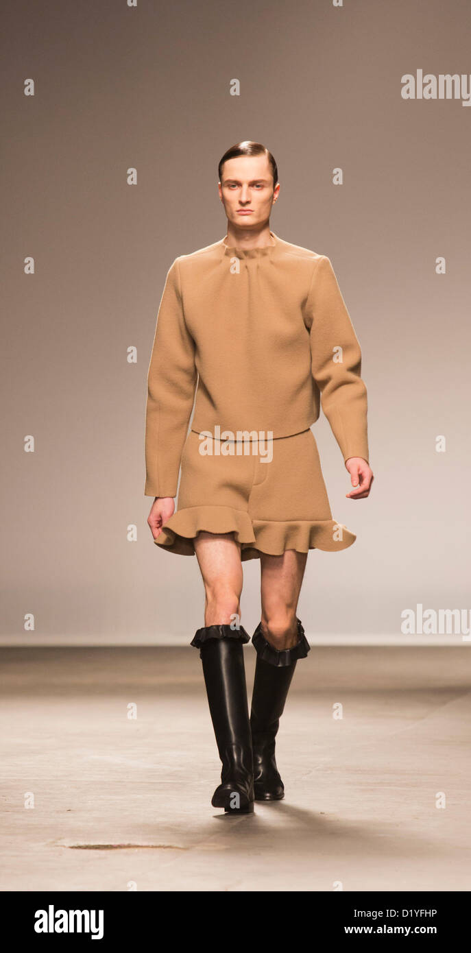 Veel commentaar ritme Wednesday, 9 January 2013. London, United Kingdom. Designer J.W. Anderson  puts his male models into short dresses and rubber-style boots at a catwalk  show during London Collections: Men. Menswear fashion event which