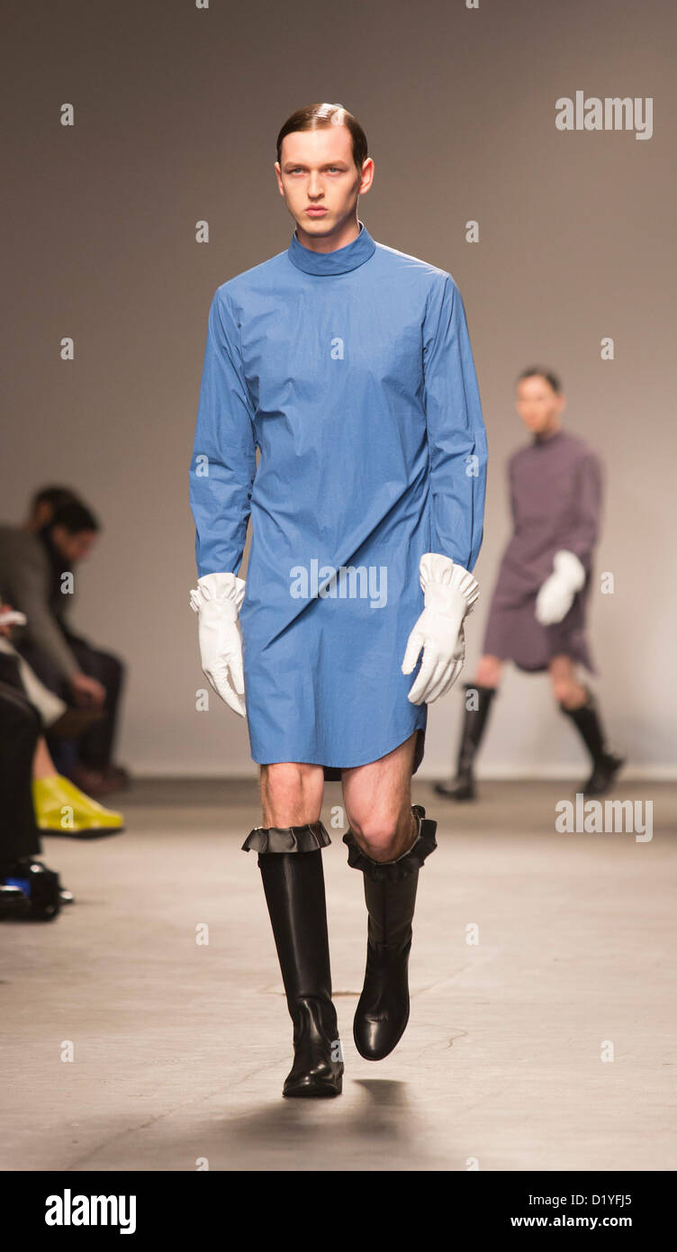 Veel commentaar ritme Wednesday, 9 January 2013. London, United Kingdom. Designer J.W. Anderson  puts his male models into short dresses and rubber-style boots at a catwalk  show during London Collections: Men. Menswear fashion event which