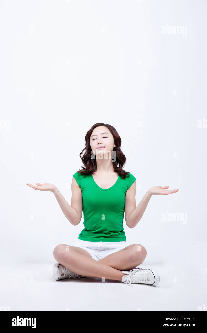 a-woman-sitting-on-the-floor-with-hand-gesture-stock-photo-alamy